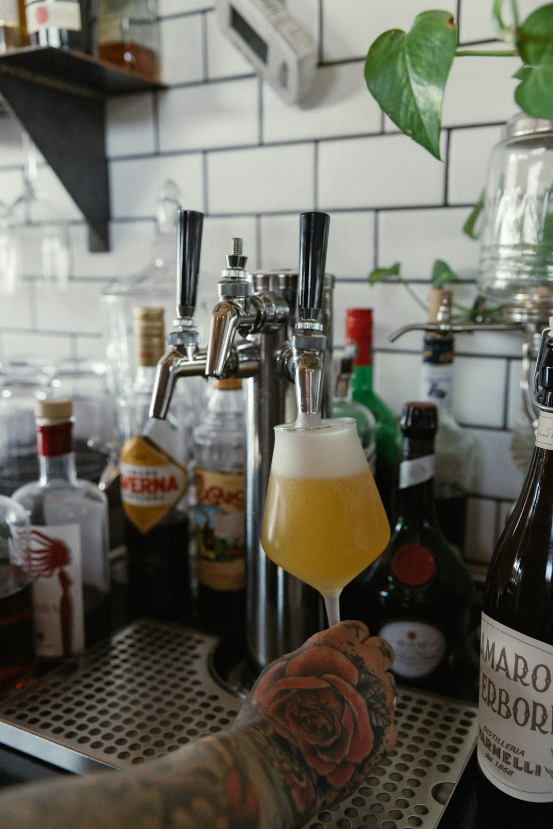 delivery-policy pouring an IPA craft beer into a glass.